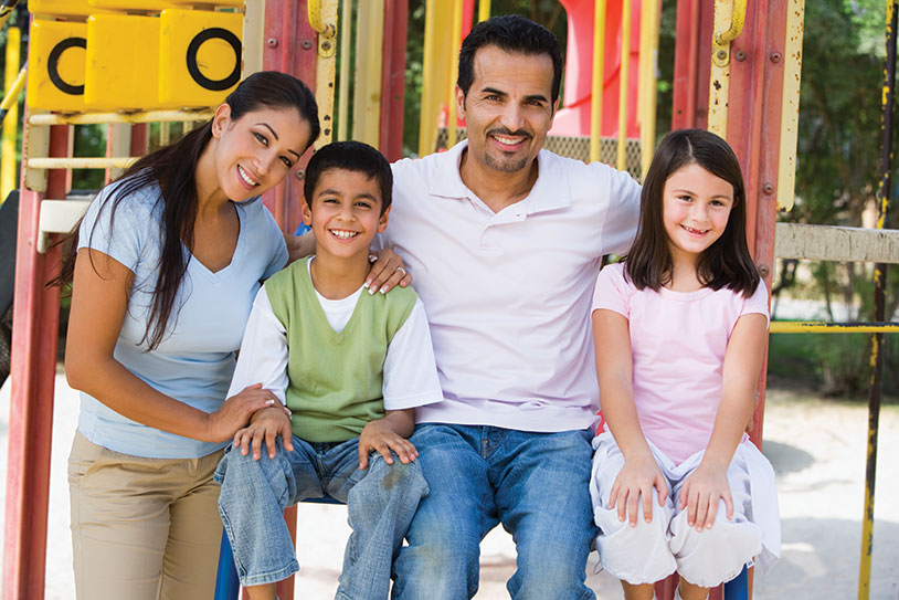 A family smiling. Links to Gifts of Life Insurance