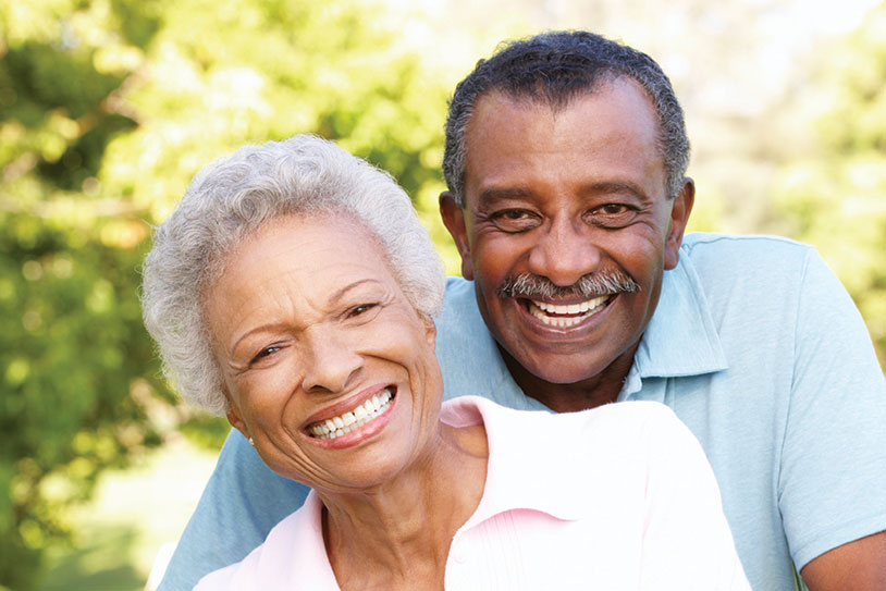 A couple smiling. Links to Beneficiary Designations
