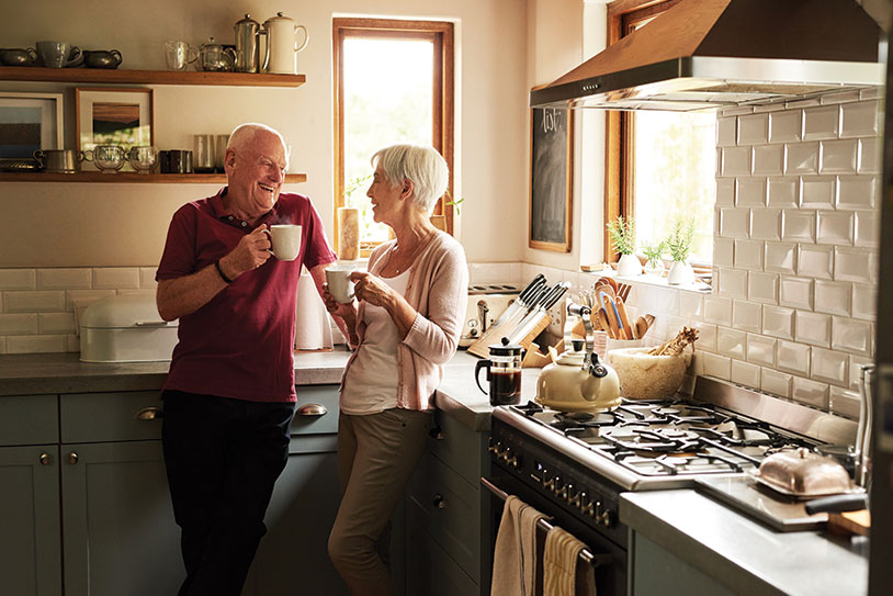 Couple in the kitchen drinking coffee. Links to Gifts of Appreciated Securities