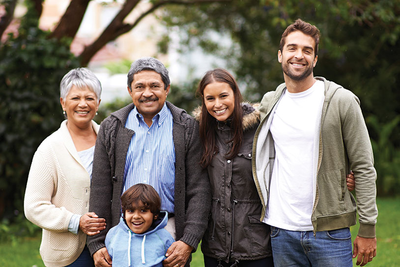 A large family smiling. Links to Gifts of Real Estate
