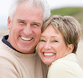 A couple smiling. Links to Gifts That Pay You Income