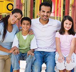 A family smiling. Links to Gifts of Life Insurance